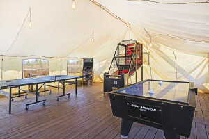 Resort Amenities Inside of game tent with ping pong table, air hockey, and basketball